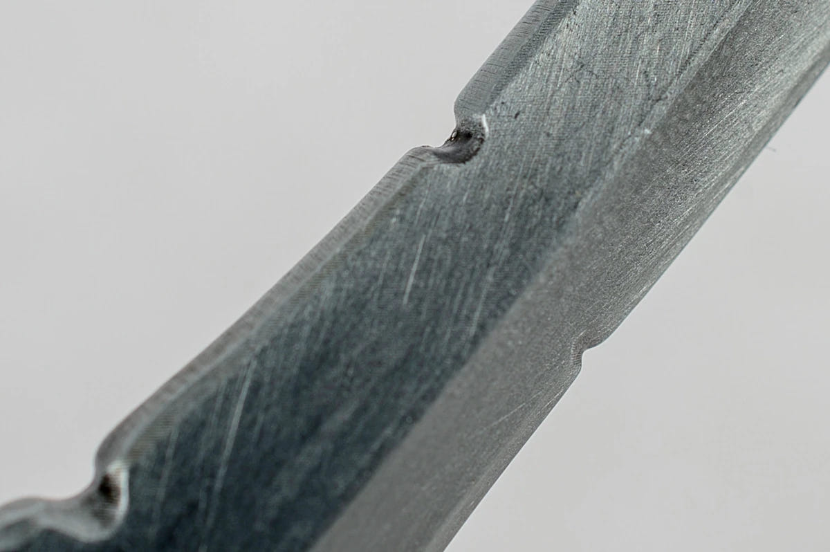 Close-up of the brushed blade edge on the Tyranids Bonesword bottle opener