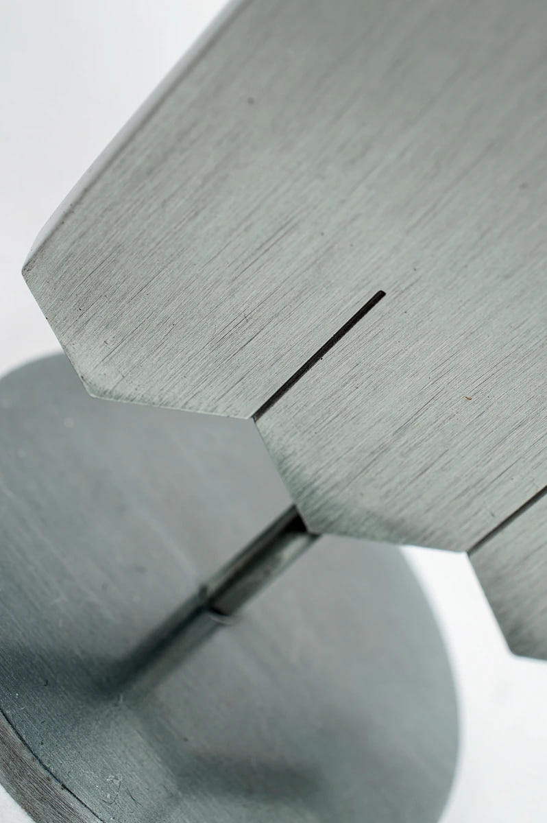 Close-up of the brushed metal Ultramarines desk banner stand and base joint