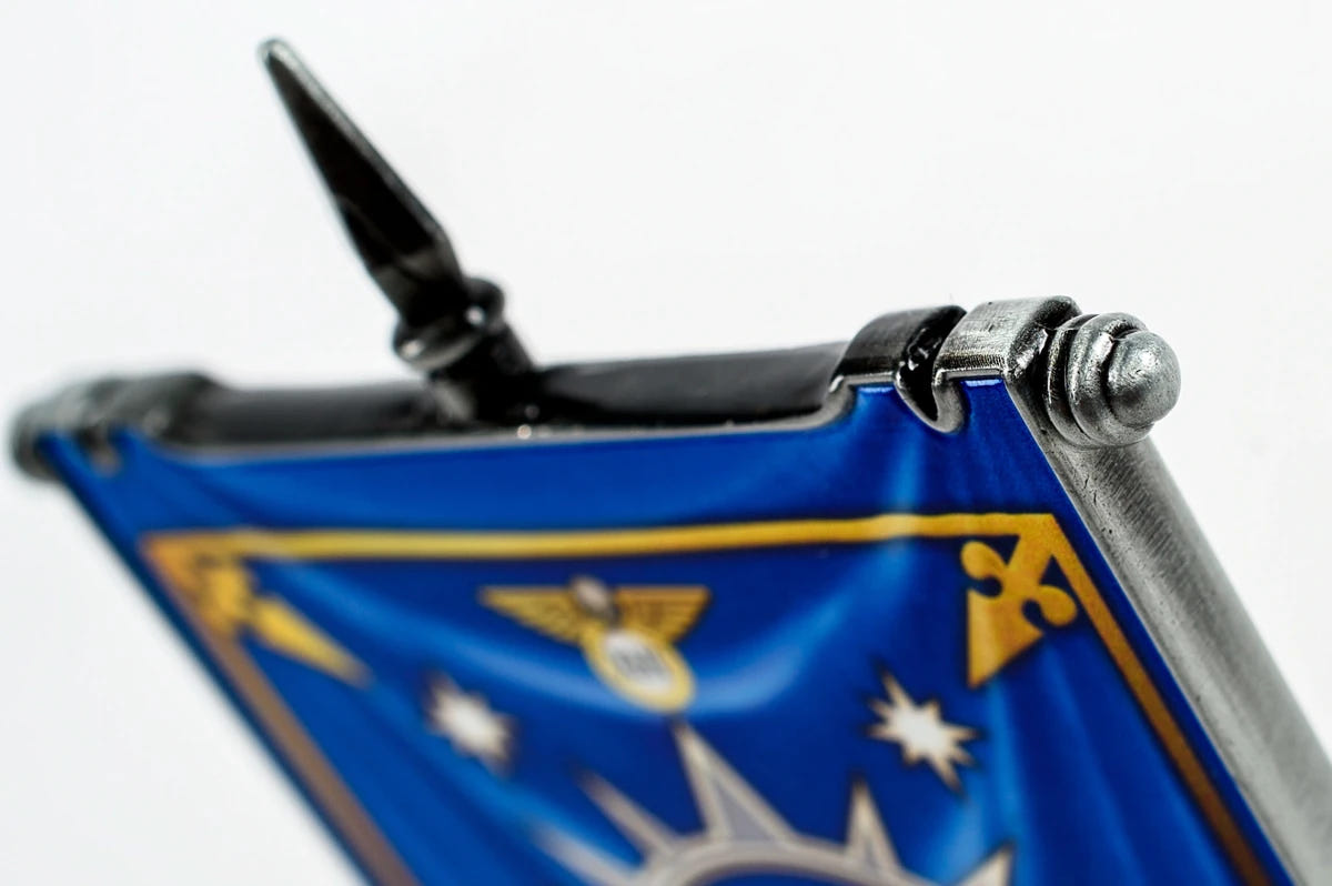 Close-up of Ultramarines desk banner top bar and spear finial above blue printed heraldry