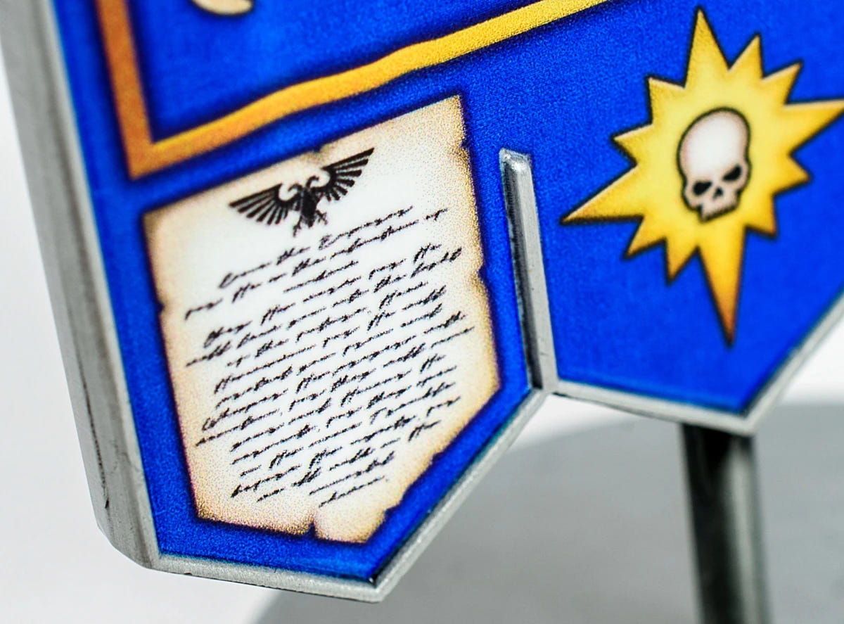 Close-up of Ultramarines banner parchment scroll, aquila and skull sunburst detail