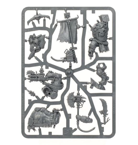 A gray plastic sprue containing multiple unpainted miniature figurines and accessories, isolated on a solid white background.
