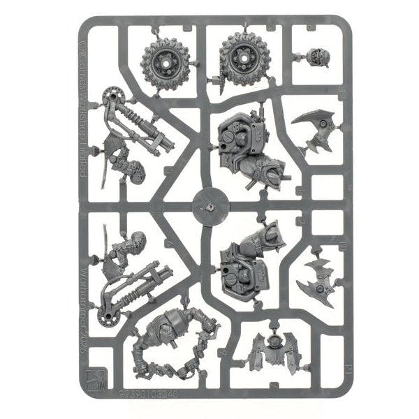 A gray plastic sprue containing various miniature model parts, including gears, mechanical components, and small figurines, isolated on a white background.
