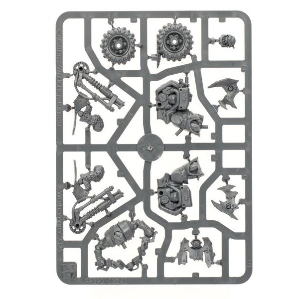 A gray plastic sprue containing various miniature model parts, including gears, mechanical components, and small figurines, isolated on a white background.