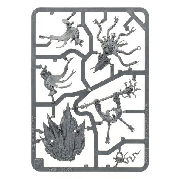 A gray plastic sprue containing multiple unpainted fantasy miniature figures and terrain pieces, isolated on a solid white background.