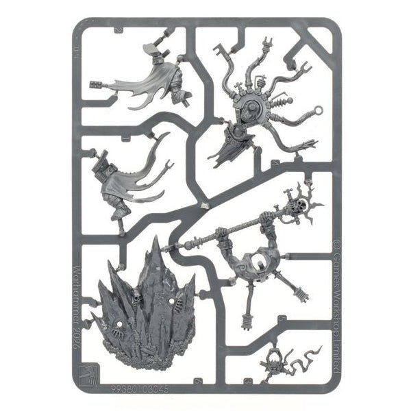 A gray plastic sprue containing multiple unpainted fantasy miniature figures and terrain pieces, isolated on a solid white background.
