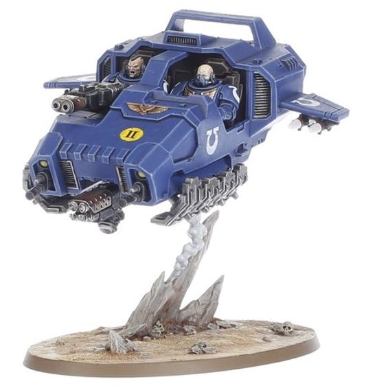 A blue sci-fi vehicle model mounted on a rocky display base, photographed against a plain white background.