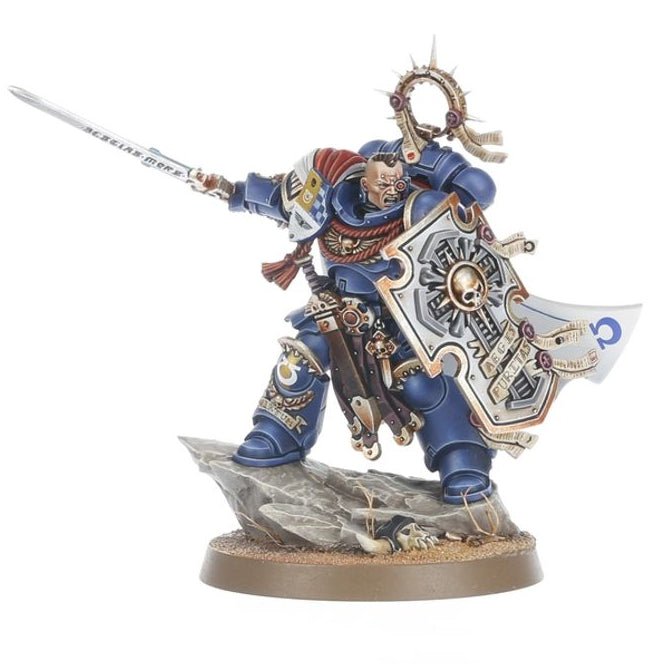 A painted miniature figurine of a warrior character in blue armor holding a sword and shield, mounted on a rocky base against a plain white background.