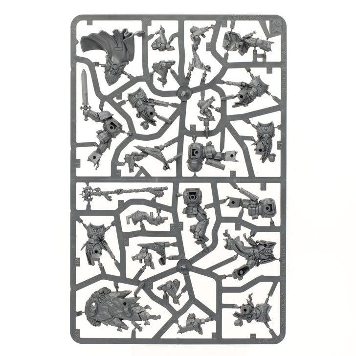 A rectangular gray plastic sprue holding multiple unpainted miniature figures and terrain pieces, photographed on a plain white background.