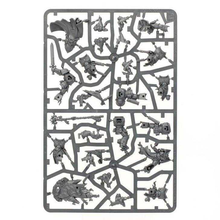 A rectangular gray plastic sprue holding multiple unpainted miniature figures and terrain pieces, photographed on a plain white background.