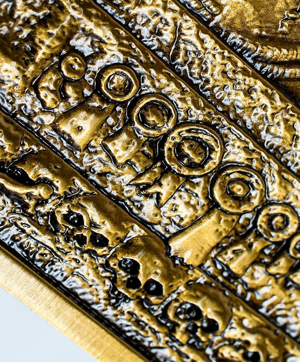 Close-up of the carved skulls and machinery at the base of the Emperor ingot