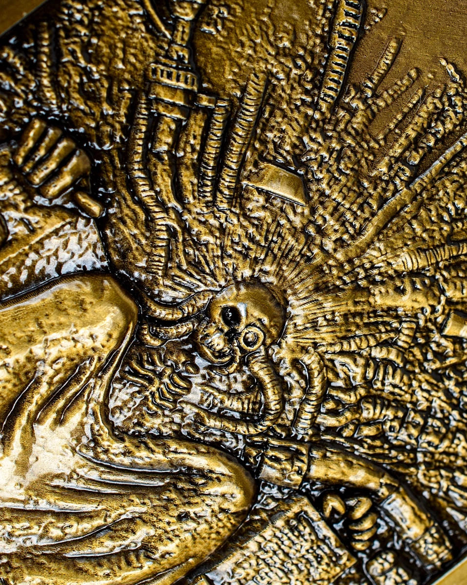 Close-up of the Emperor's skull-like face and radiating throne detail on the ingot