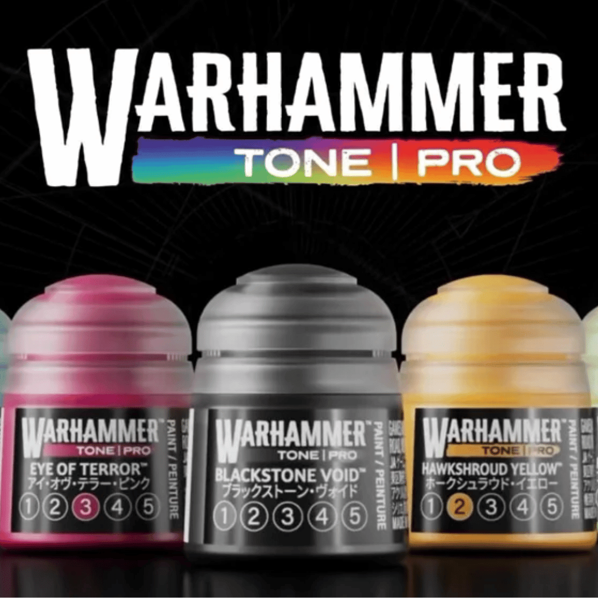 Three Warhammer Tone Pro paint bottles displayed against a black background with large Warhammer branding above. The bottles show pink, dark gray/black, and yellow-gold paint colors, with label text including Eye of Terror, Blackstone Void, and Hawkshroud Yellow.