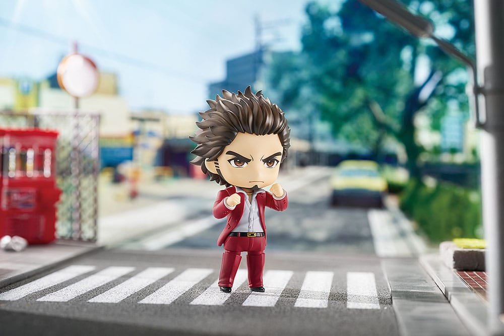 Ichiban Kasuga Nendoroid on a daytime street crossing, fist raised