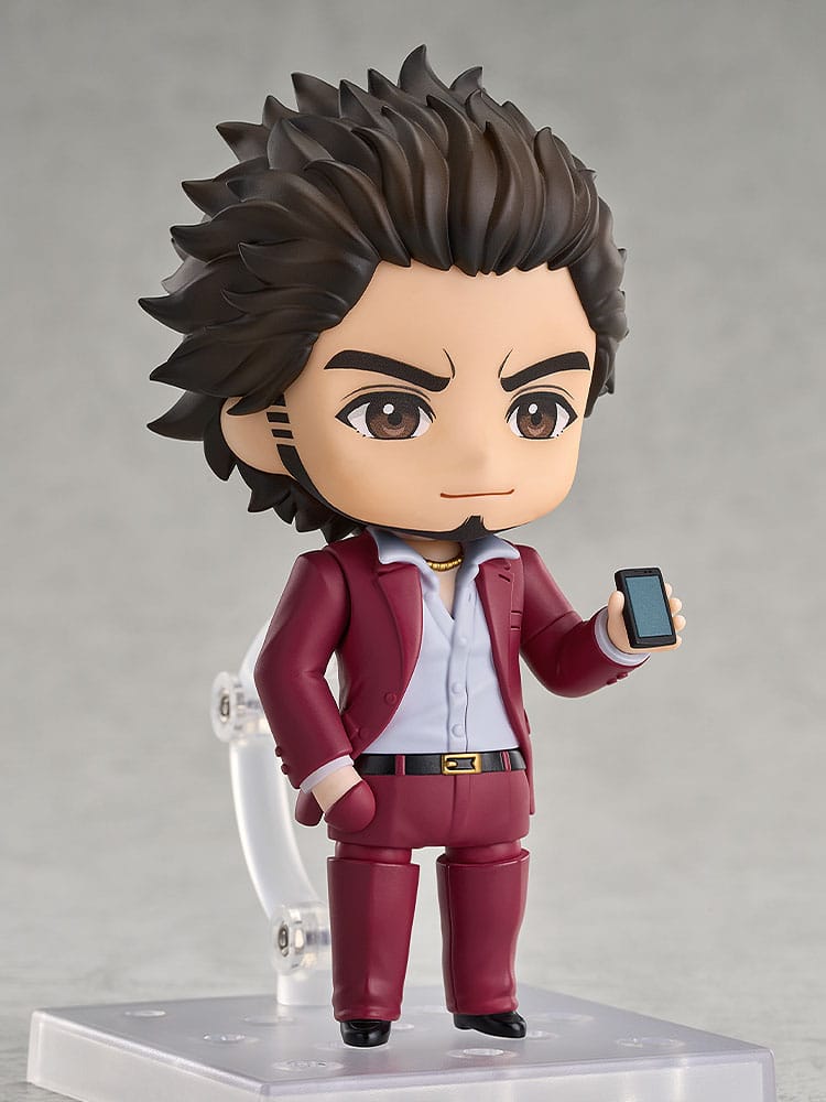 Ichiban Kasuga Nendoroid holding a smartphone, supported by the clear stand