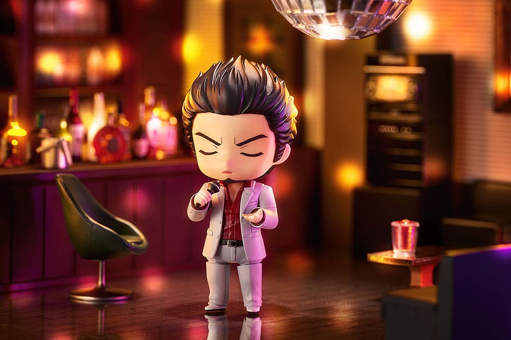 Kazuma Kiryu Nendoroid singing into a microphone in a karaoke bar setting