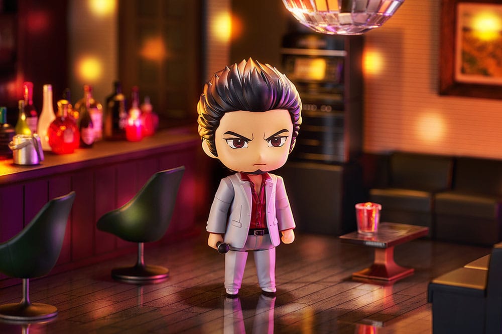 Kazuma Kiryu Nendoroid standing in a warmly lit bar with disco ball above