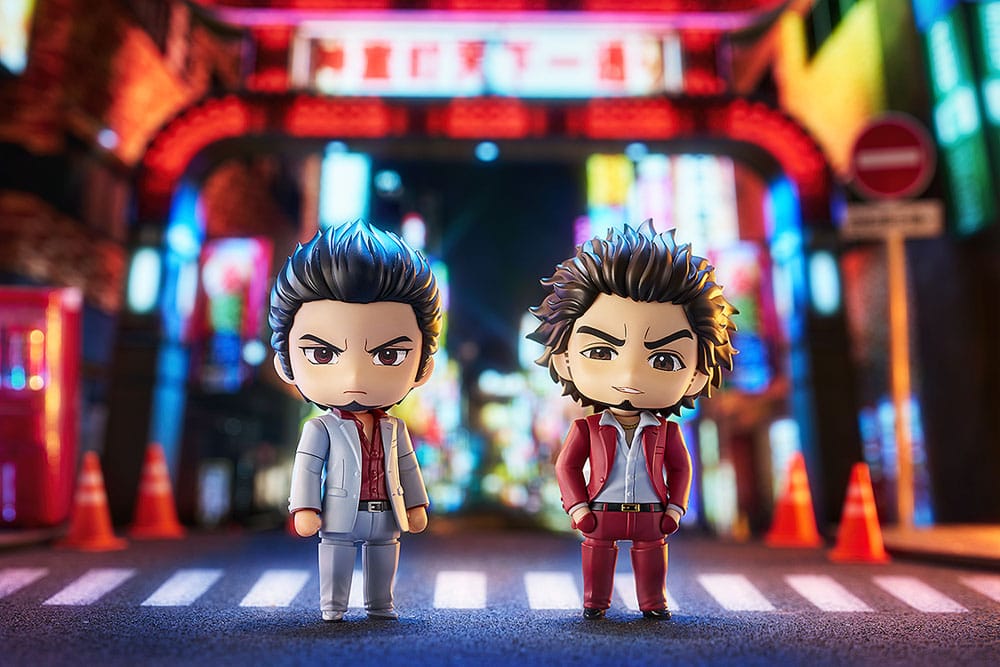 Kiryu and Ichiban Yakuza Nendoroids posed together under a neon street arch