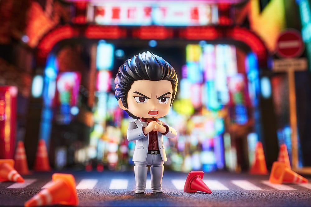 Kazuma Kiryu Nendoroid shouting in a neon street diorama with scattered traffic cones