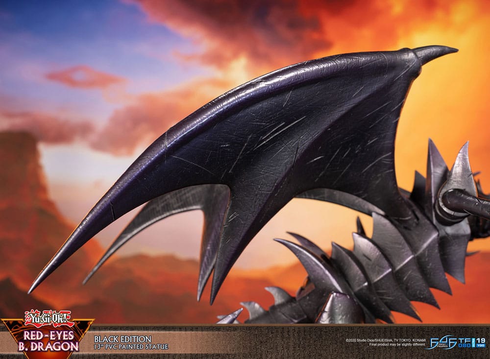 First 4 Figures Yu-Gi-Oh! Red-Eyes B. Dragon black PVC statue, close-up of the wing against a sunset sky
