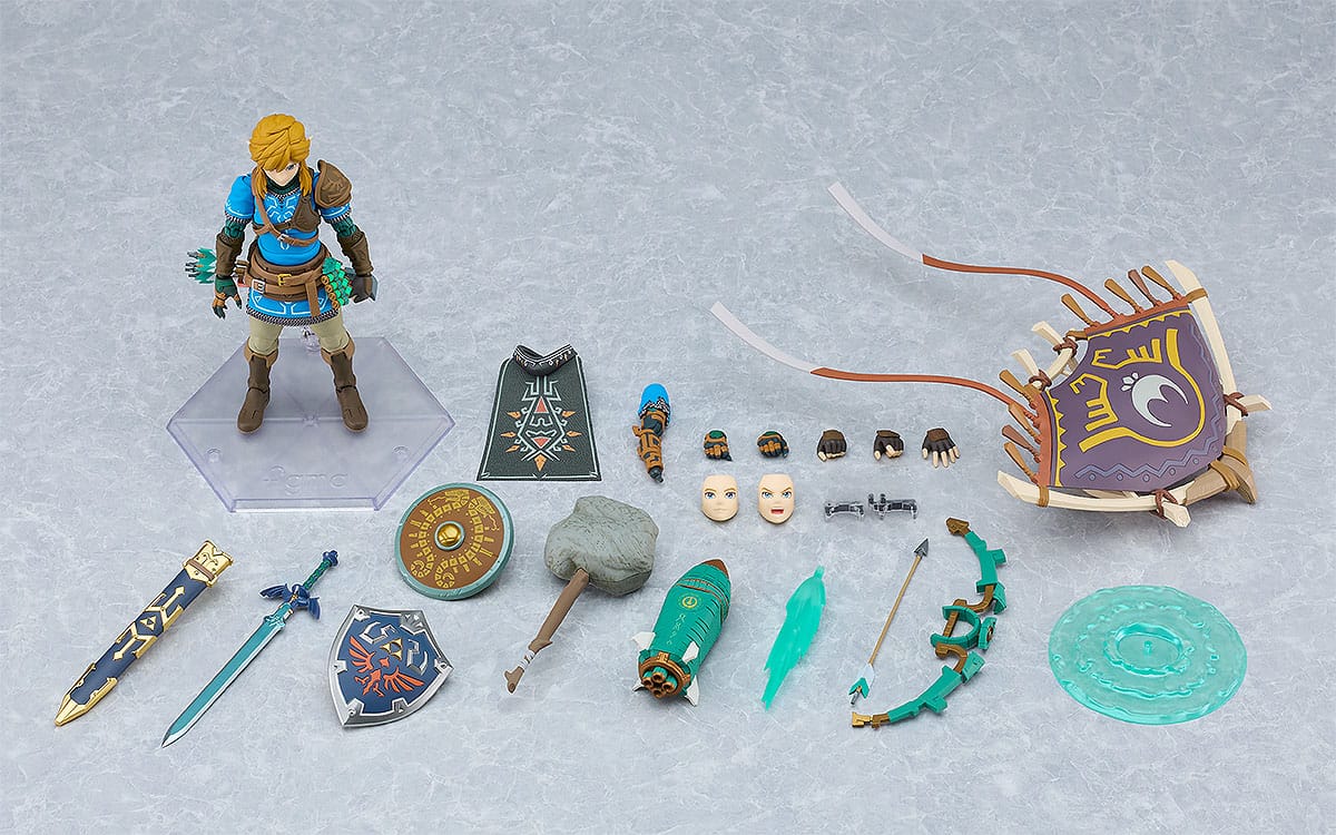 figma Link DX Edition figure and full set of accessories laid out on a grey background