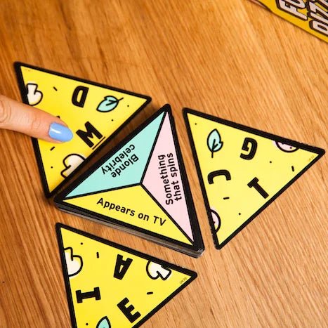 P for Pizza cards on a wooden table with a hand pointing to a letter slice